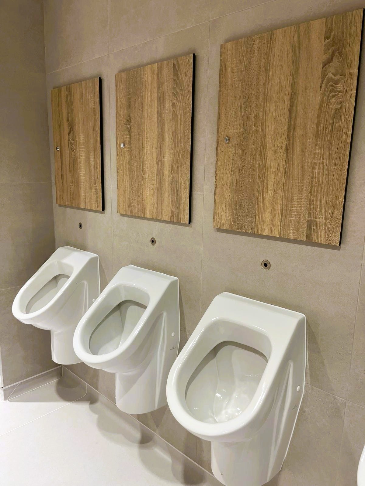 Wood-effect IPS urinal panels in a commercial washroom
