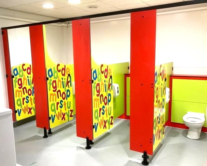 Digitally printed Rainbow school toilet cubicles with themed graphics
