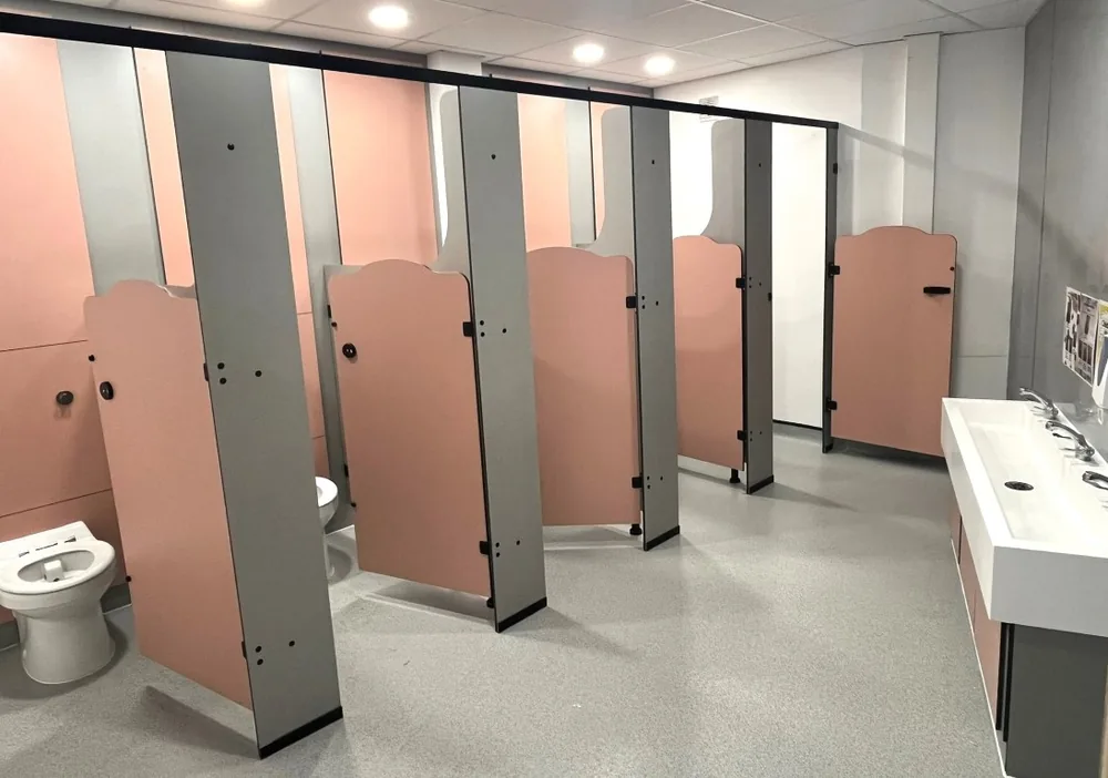 Rainbow school toilet cubicles in a girls' washroom